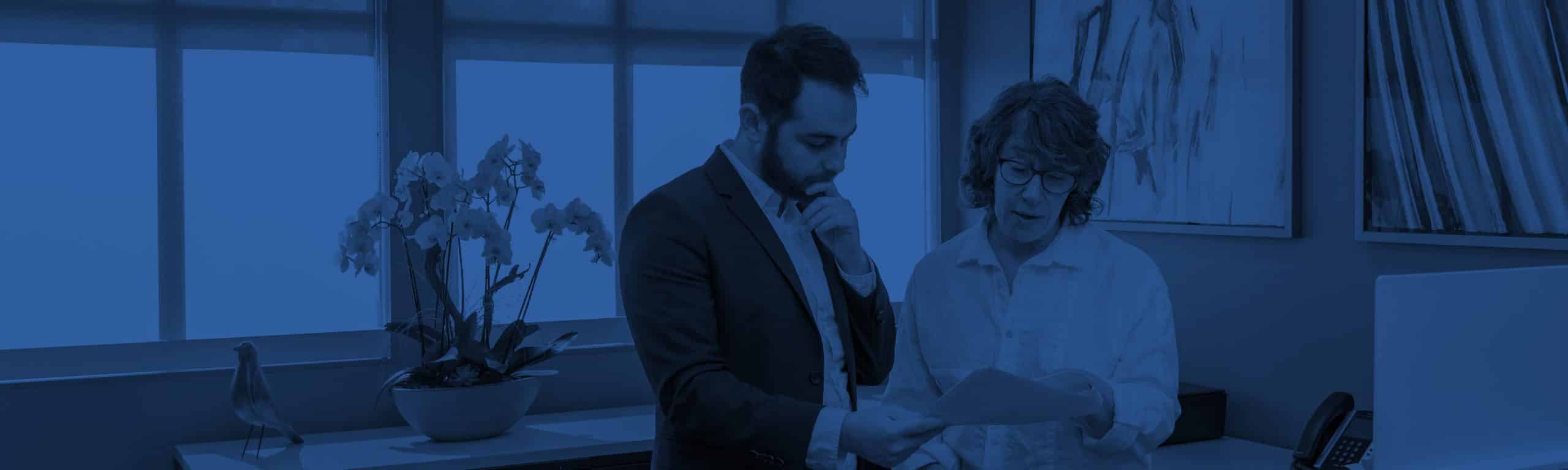 Hali Croner looking at a document with a consultant