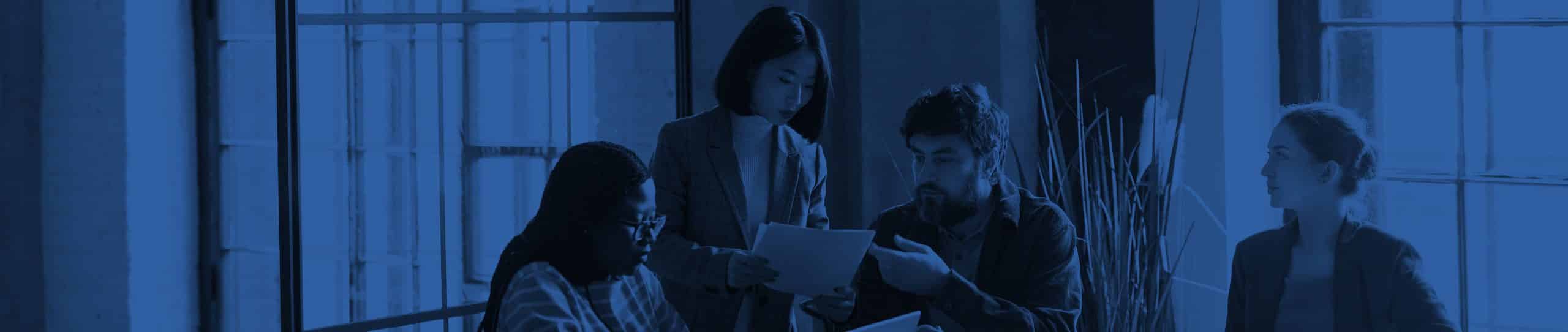 Four people collaborating around a desk
