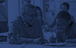 Volunteers tutoring students in classroom